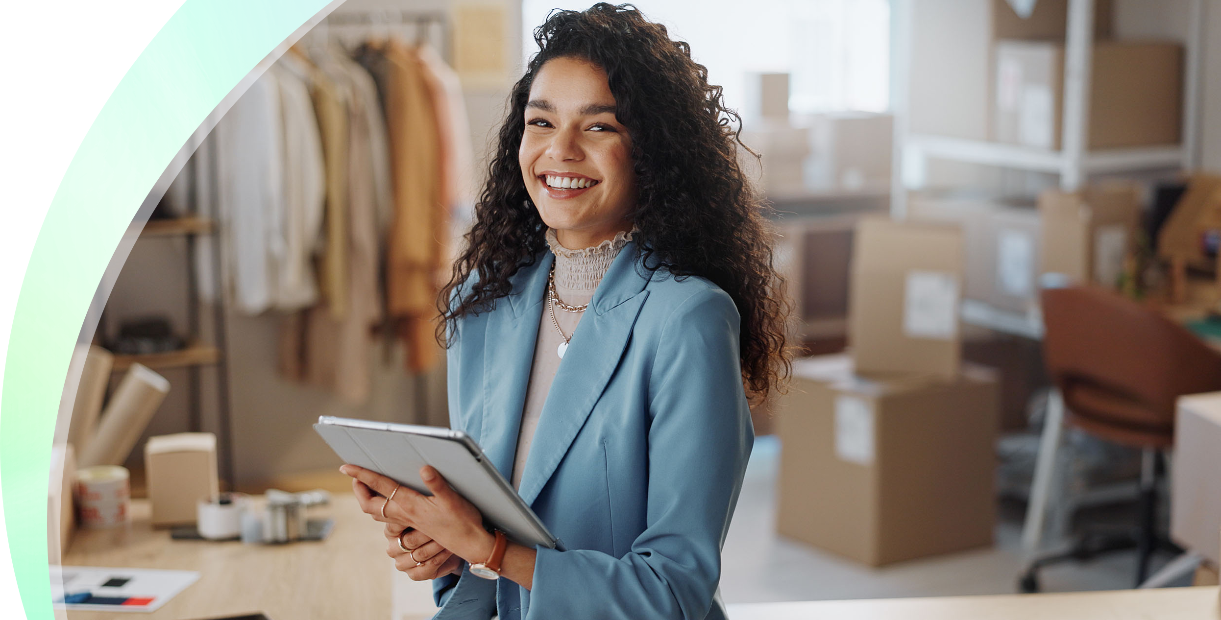 Smiling businesswoman holding a tablet in a bright studio
